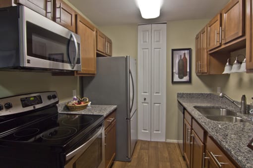 Renovated kitchen with granite counters, vinyl flooring and new cabinets