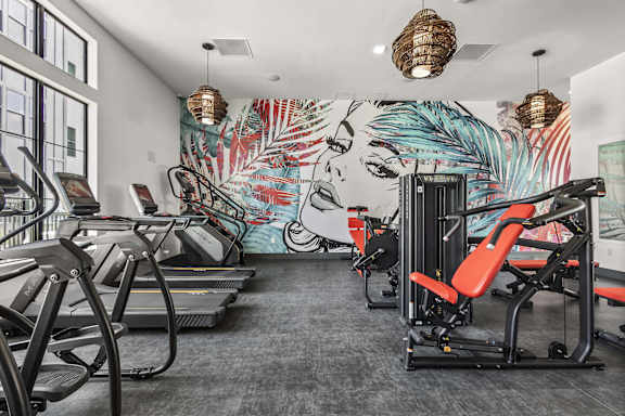 A gym with treadmills and exercise equipment.