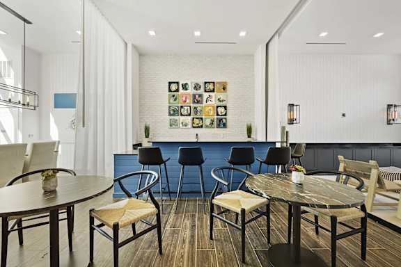 A room with a white wall and a blue couch.
