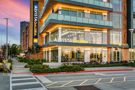 The Alvista Galleria is a modern building with a glass facade and a large entrance.