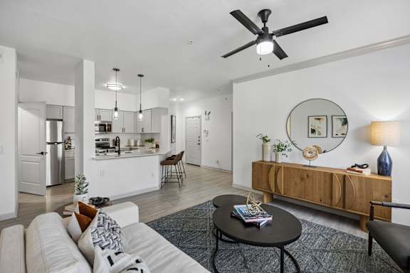 A modern living room with a white sofa and a black coffee table.