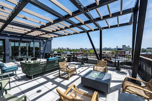 A patio with a table and chairs under a roof.