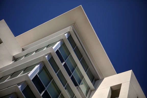 A modern building with a white facade and large windows. at West Park Apartments, San Diego, 92108