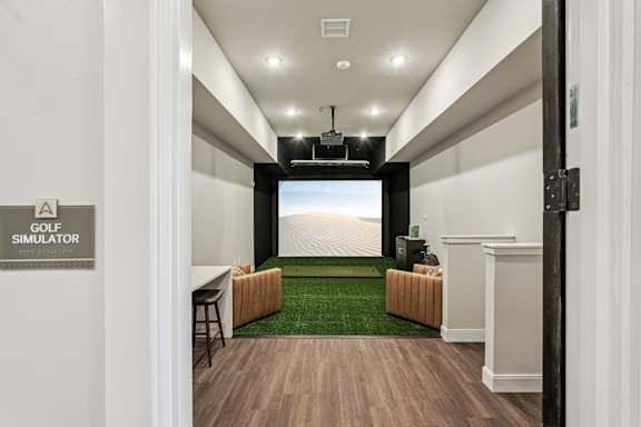 A room with a golf simulator sign on the wall at The Stadler Luxury Apartments, Bradenton, Florida