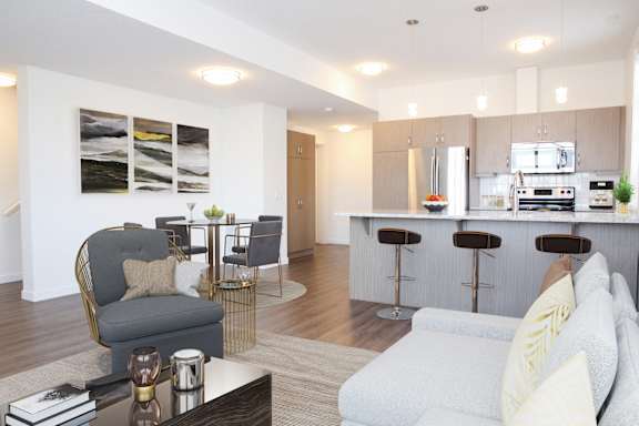 A modern living room with a grey sofa and a bar area.
