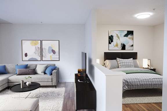 a bedroom with a bed and a living room with a couch