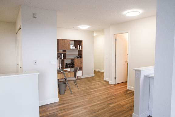a view of a living room and a dining room with wood flooring and a