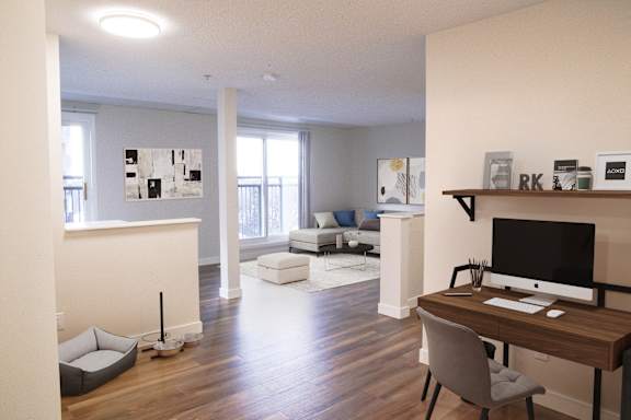 a view of a living room with a desk and a television