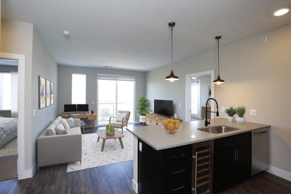 an open kitchen and living room with a couch and a table
