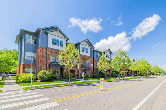 A row of townhouses with a crosswalk in front.