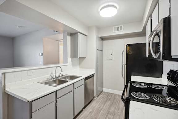 A 3D floor plan of a small apartment with a living room, kitchen, and two bedrooms.