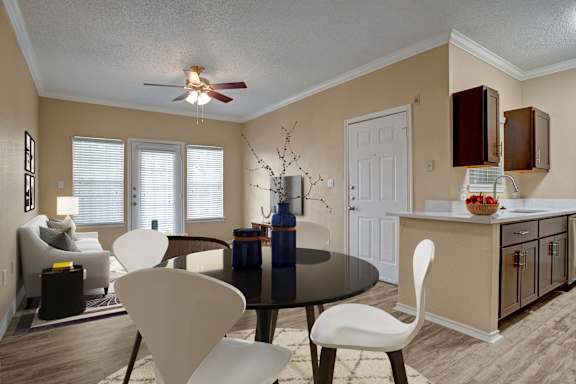 A dining room with a table and chairs.