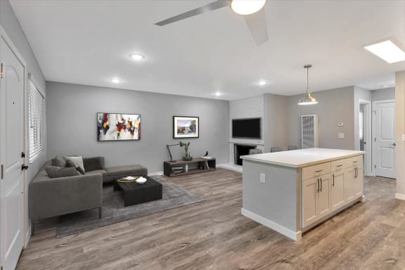 a living room with a kitchen and a couch and a tv