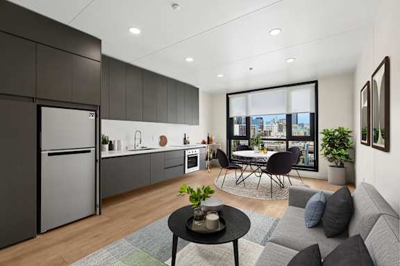 A modern kitchen with a dining area and a view of the city.
