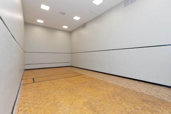 a large white room with a wooden floor and a squash court at Lakecrest Apartments, PRG Real Estate Management, Greenville, South Carolina