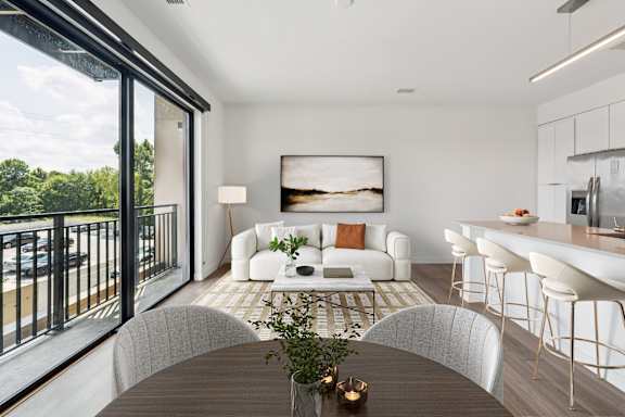 A modern living room with a large window overlooking a balcony. at Hydro, Richmond, 23224