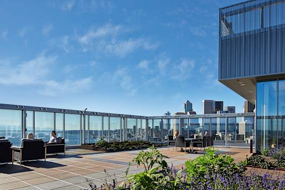 a view of the city skyline from the top of a building with a terrace