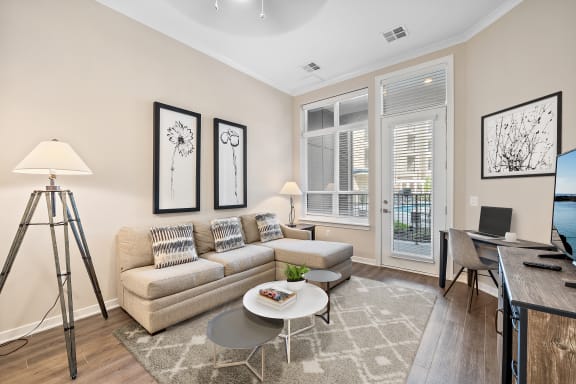 a living room with a couch coffee table and a tv
