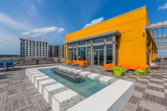 A pool with a water feature in the middle of a patio area  at The George, Wheaton, 20902