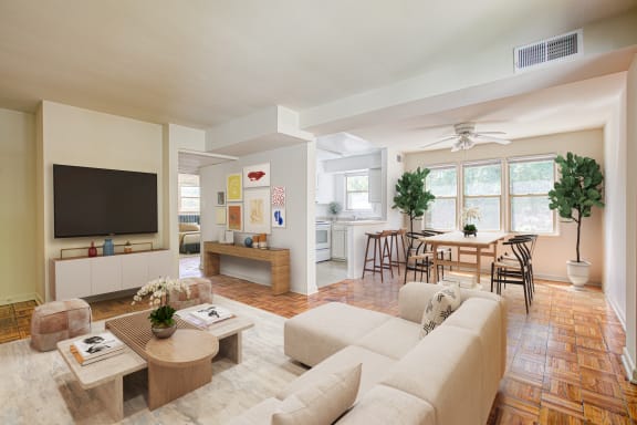 A living room with a couch, a coffee table, and a television. at Park Georgetown Apartments, Arlington, 22209
