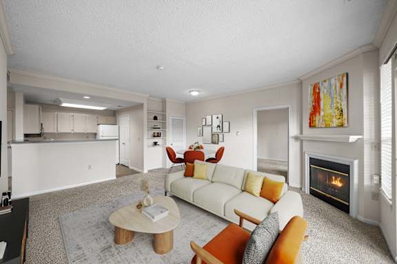 A living room with a fireplace and a couch.at The Claremont Apartment Homes, Overland Park, KS