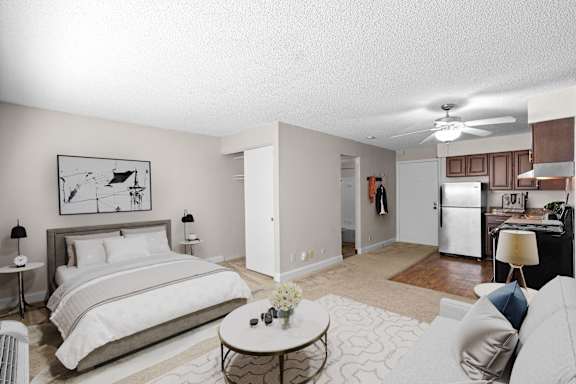 a bedroom with a large bed and a living room at Malvern Hill Apartment Homes, Kansas