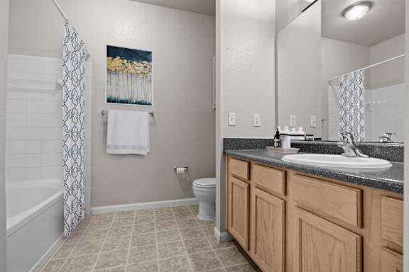 A bathroom with a toilet, sink, and shower.