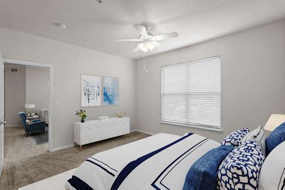 A bedroom with a large bed and a painting on the wall.