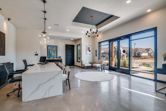 A modern home interior with a large kitchen island and dining area.