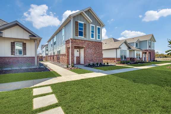 A row of houses with a clear blue sky above them.