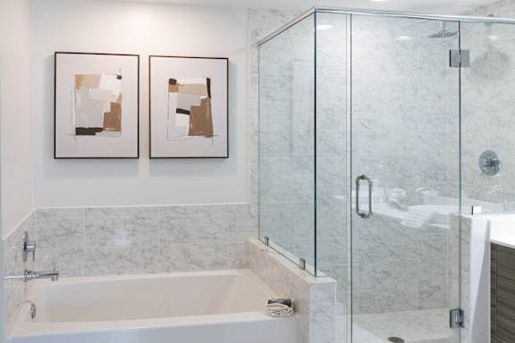 A bathroom with a white tub and a glass shower.