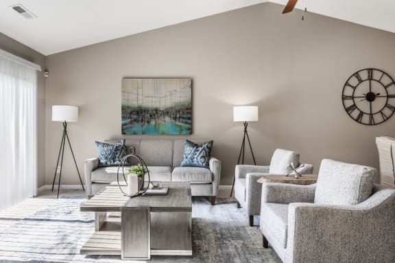 a living room with couches chairs and a coffee table