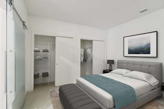 A bedroom with a large bed and a painting on the wall.