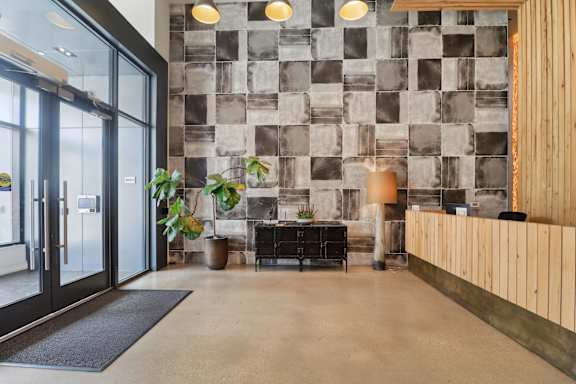 A modern office lobby with a black and white tiled wall.