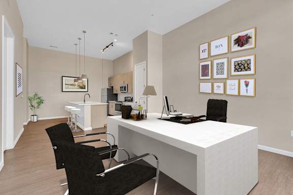 A modern home office with a white desk and black chairs.