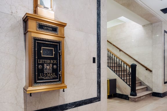 the lobby of a building with a letterbox on the wall