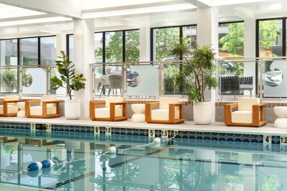 a hotel swimming pool with chairs and a water feature  at Vision on Lombard, Baltimore, MD