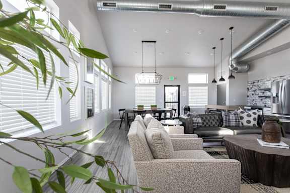 a living room with couches and chairs and a dining room
