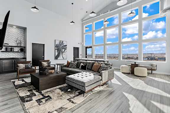 A modern living room with a large window overlooking the beach.