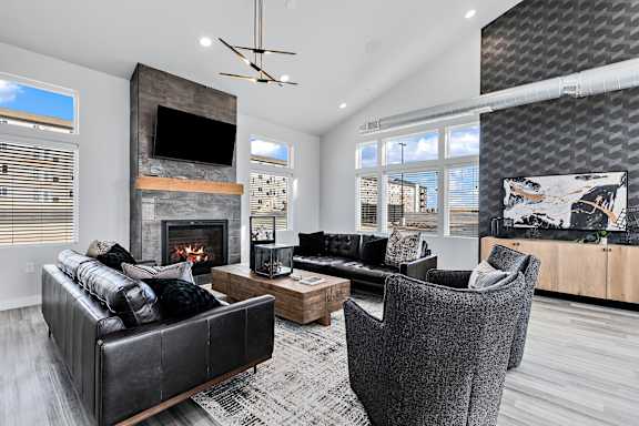A modern living room with a fireplace and a flat screen TV.