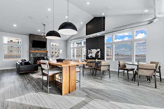 A modern living room with a fireplace and a dining table set up.