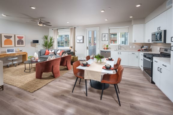 Model apartment interior showing open floor plan living/dining/kitchen area.