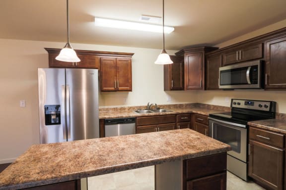 a kitchen with stainless steel appliances and wooden cabinets