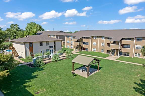 an aerial view of an apartment complex with a green lawn