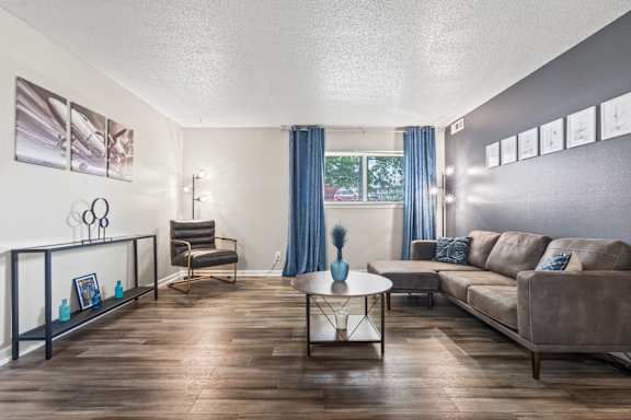 A living room with a brown couch and a coffee table.