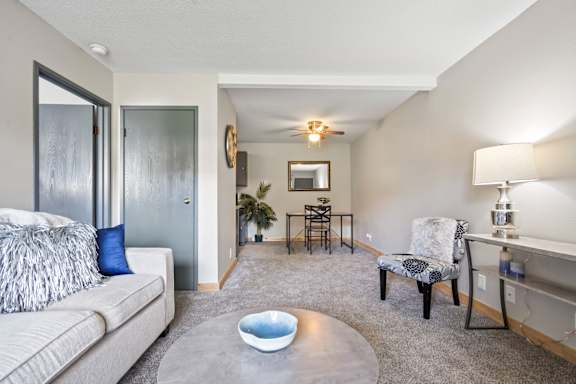a living room with a couch and a chair and a table
