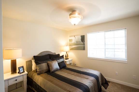Image of bedroom containing one overhead light and window