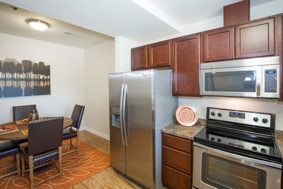 Image of stove, refrigerator, microwave and cabinets