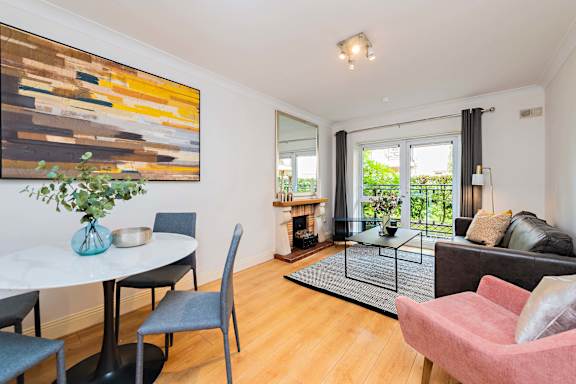 a living room with a table and chairs and a couch