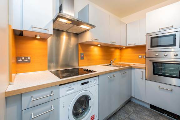 a kitchen with a washing machine and a sink